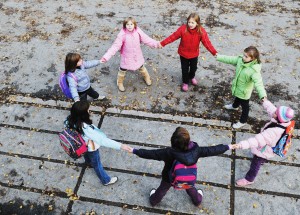 happy school girls running outdoor at sunny autumn day